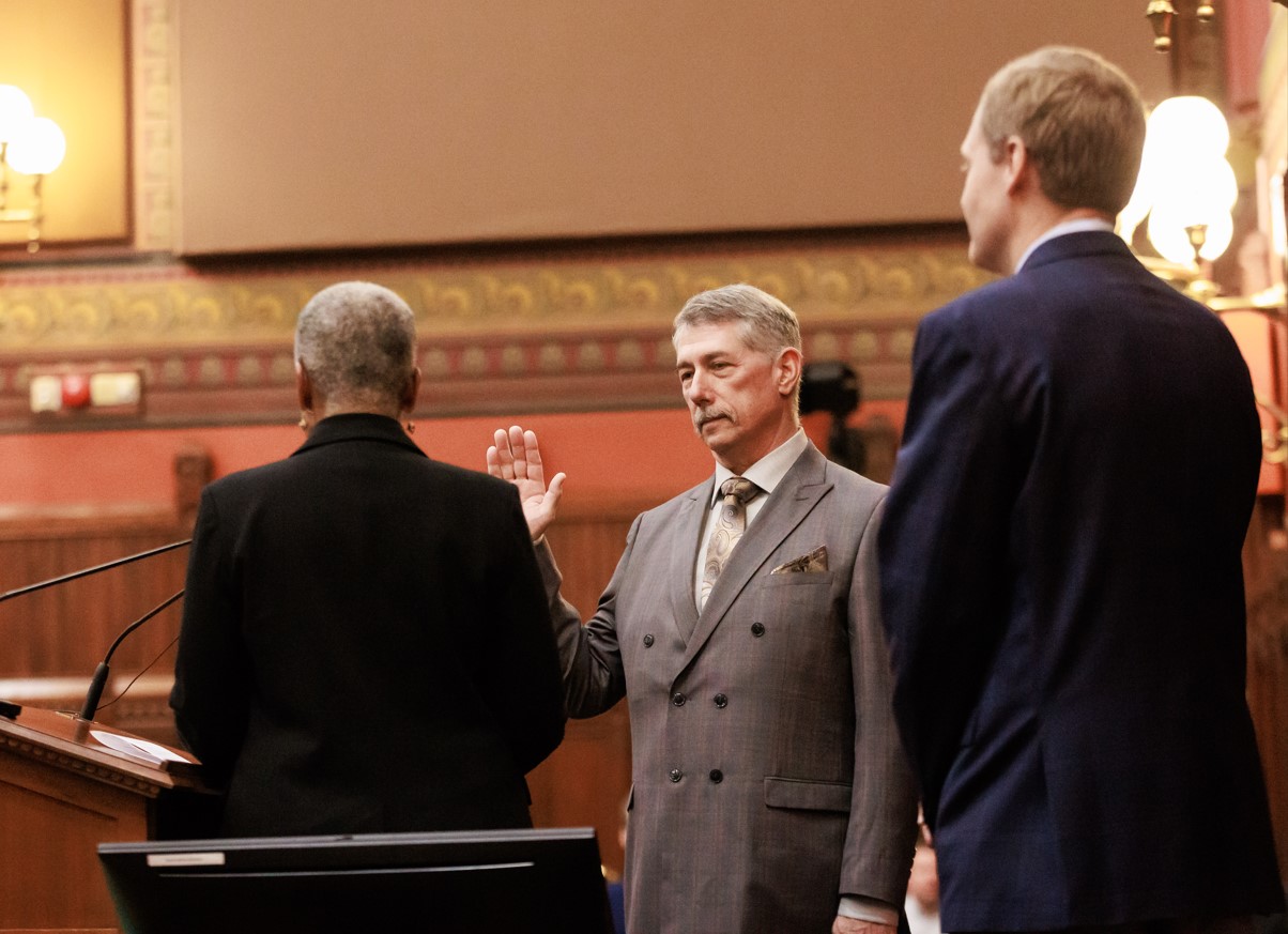 Representative Heffernan is sworn in by Secretary of the State Stephanie Thomas, while House Speaker Matthew Ritter looks on.
